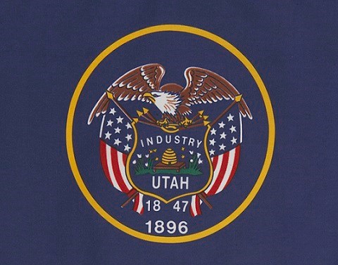 Utah flag--navy blue background, gold circle with eagle, flag, Industry, Utah, 1847, 1896 inside