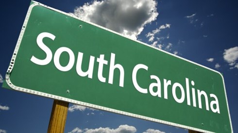 South Carolina road sign against blue sky and clouds