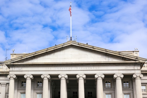 The U.S. Treasury Department Building with a white cloudy sky in the background