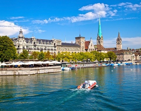 Zurich Switzerland Cityscape On Canal With Speedboat