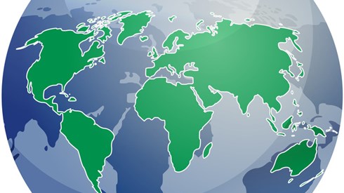 A transparent globe with continents in green and their reflection in blue