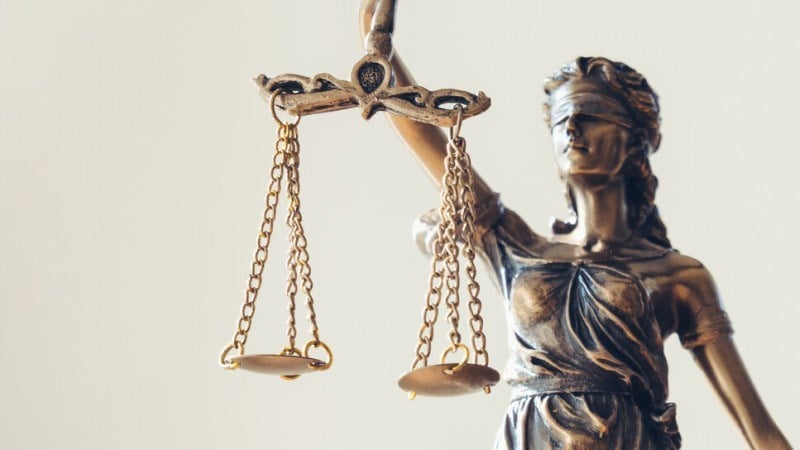 Small figure of Lady Justice holding scales