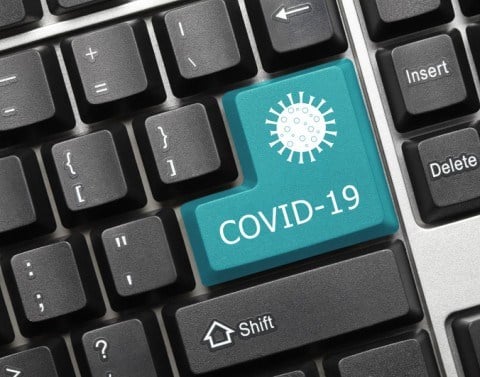 Blue COVID19 key on a black computer keyboard
