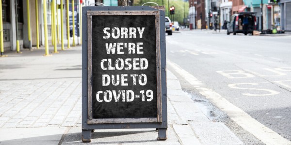 Sorry Closed for COVID-19 on Standing Advertising Sign on Sidewalk