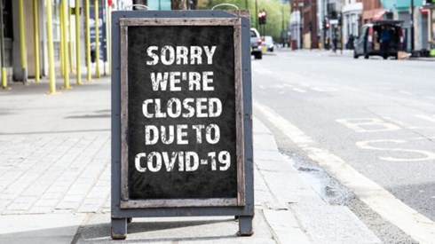 Sorry Closed for COVID-19 on Standing Advertising Sign on Sidewalk