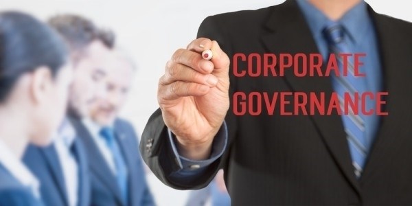Businessman writing Corporate Governance