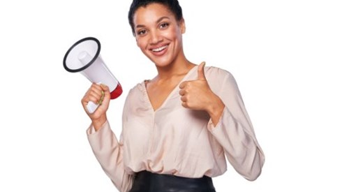 Businesswoman with megaphone giving thumbs up