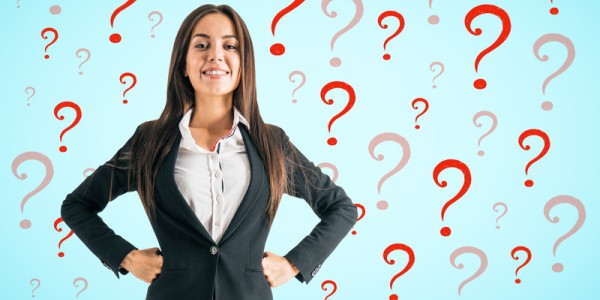 Confident businesswoman surrounded by red and shadowed-red question marks