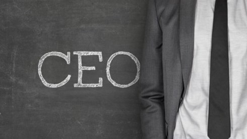CEO Written On Chalkboard Next To Businessman