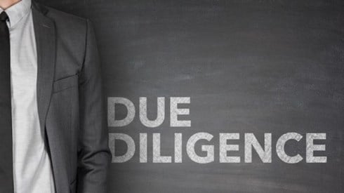 Businessman standing with Due Diligence written next to him