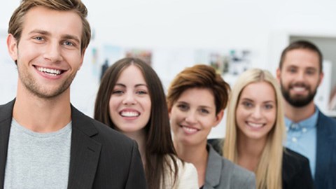 Five young business professionals smiling